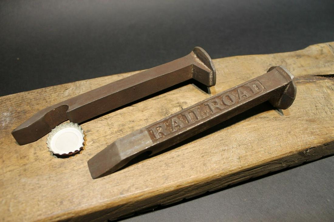 Iron Railroad Spike Soda Beer Bottle Cap Opener: 6 3/4" Long x 1 3/4" Wide Great reproduction heavy solid iron bottle opener. This piece was made to look just like an antique, but is actually new made. Great for use or display! Reserve: $10.00 Shipp