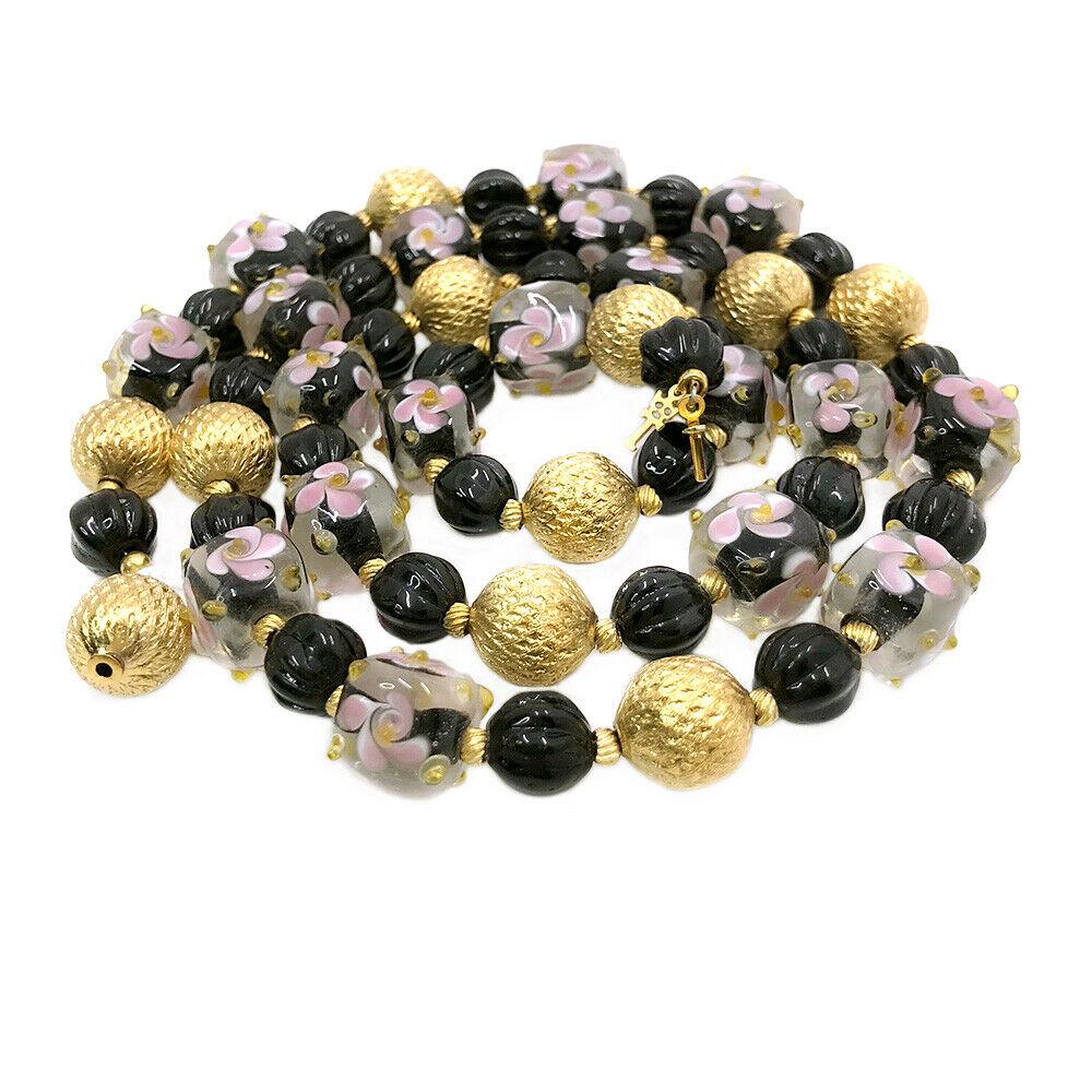 Crown Trifari Art Class Necklace: Circa 1955 a strand of lamp-work art glass beads, black melon glass beads and gold tone metal beads necklace with Crown Trifari logo tag. Dimensions: 29 x 0.5 x 0.5 inch Reserve: $50.00 Shipping: Dome