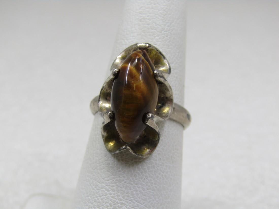 Vintage Sterling Tiger's Eye Ring, Sz. 6.25, Mexico: Vintage Sterling Tiger's Eye Ring, Sz. 6.25, Mexico. Marked .925 and tested. Age is appx. 1970's-1980's. Appx. 4.73 gr. Marquise tiger's eye cabochon that is appx. 15mm by 7.5mm in an open dramatic sc