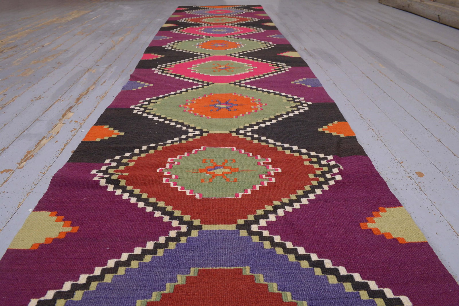 2.7x12.8 Turkish Flatweave Colorful Pink Black Rug: Title: 2.7x12.8 Turkish Flatweave Colorful Pink Black Rug Origin: Turkey Date/Period: 1960 - 1970 Dimension: Width: 2.7 feet Length: 12.8 feet Materials: Wool and Cotton Description: This one-of-a-kin