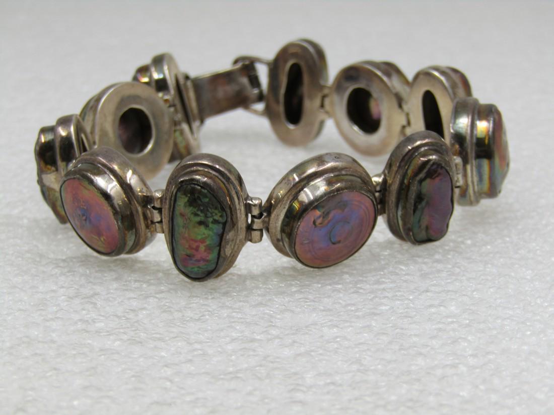 Vintage Sterling Mabe Pearl Bracelet, Bezel-Set, Purple, 7.75": Vintage Sterling Mabe Pearl Bracelet, Bezel-Set, Purple, 7.75" long and appx. .75" wide. 11 Links alternating between round and elaongated, baroque bumpy shimmery purple mabe pearls. Weight is app. 57