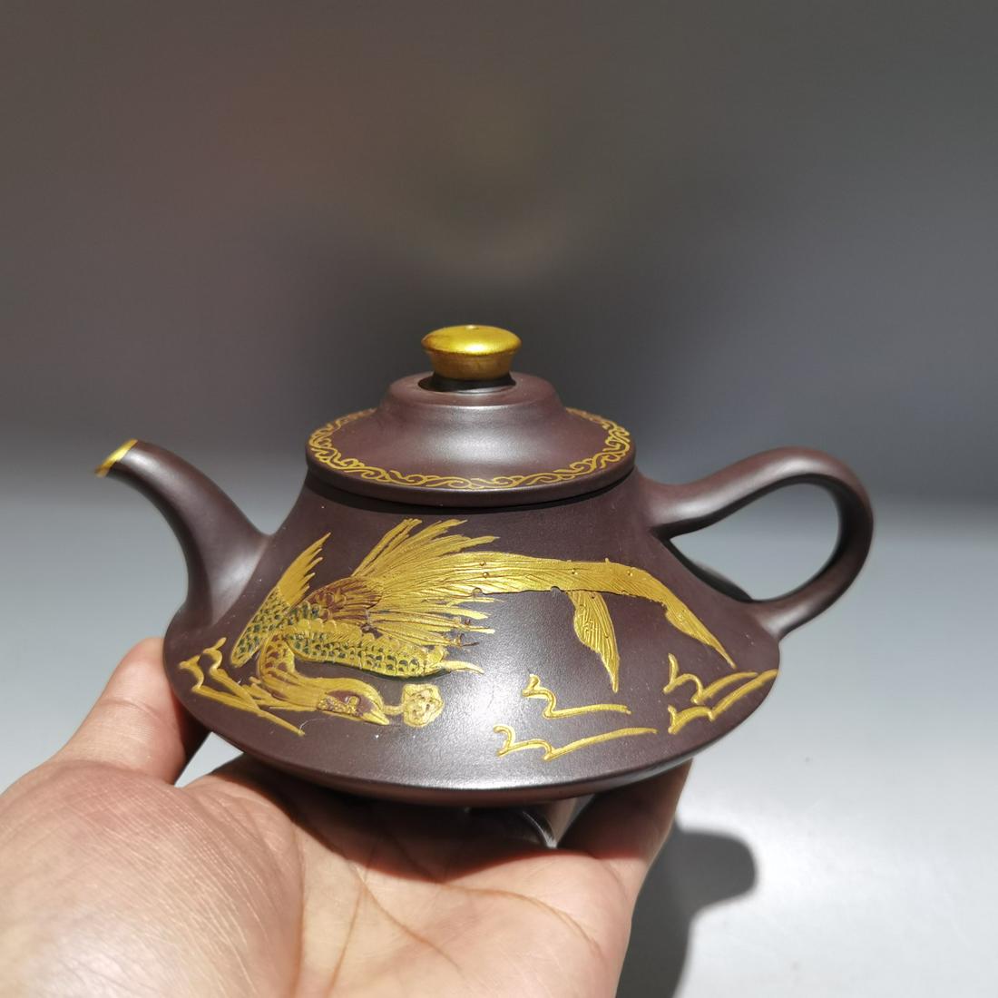 Chinese Gilt Gold Yixing Zisha Clay Teapot w Artist Signed: Title: Chinese Gilt Gold Yixing Zisha Clay Teapot w Artist Signed Date/Period: After 1900 Origin: Chinese Dimension: Dimension: 140 x 70(mm) 5.51 x 2.75 (inches) Materials: Zisha Clay Reserve: $169.00