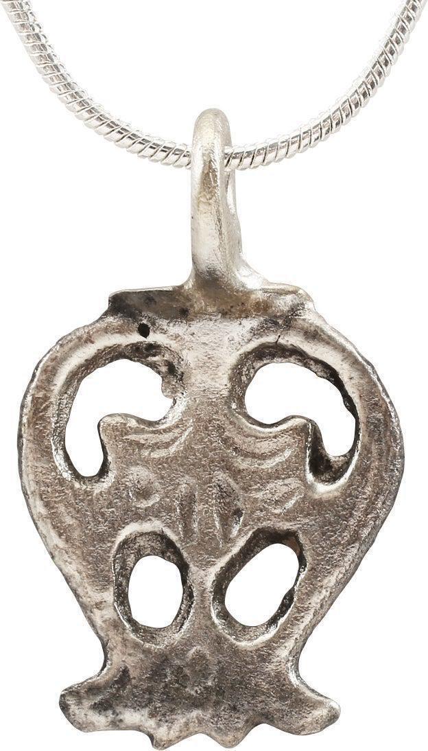 FRENCH GOTHIC LADY'S PENDANT NECKLACE, C.1300-1500: Stylized heart form, pierced with a central armorial device. The bottom of the scalloped "fishtail" form. The form of the heart is fully cusped, iconic as descended from the earlier Viking application