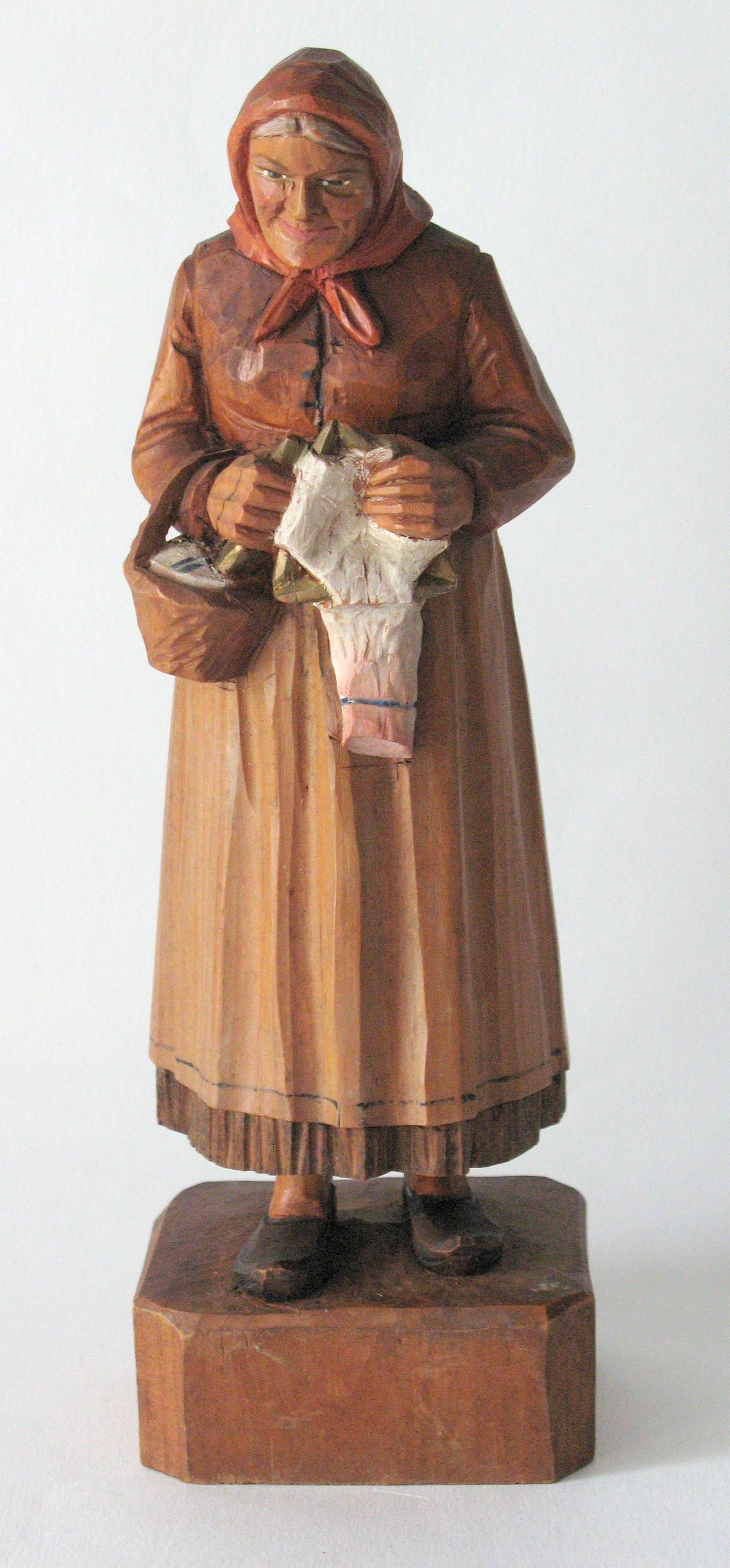 Antique folk art wood carving of an old woman. (1 of 3)
