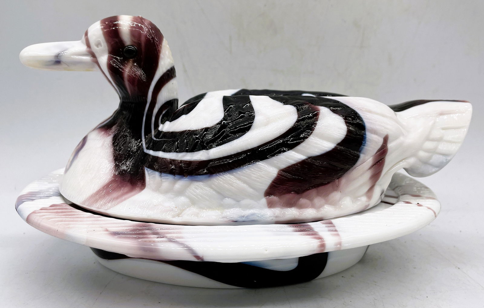 VINTAGE PURPLE & WHITE SLAG GLASS DUCK ON NEST: Title: VINTAGE PURPLE & WHITE SLAG GLASS DUCK ON NEST Date/Period: UNKNOWN Dimension: approx 8.25 x 4.75 Material: GLASS Additional Information: VINTAGE PURPLE & WHITE SLAG GLASS DUCK ON NEST CANDY BO