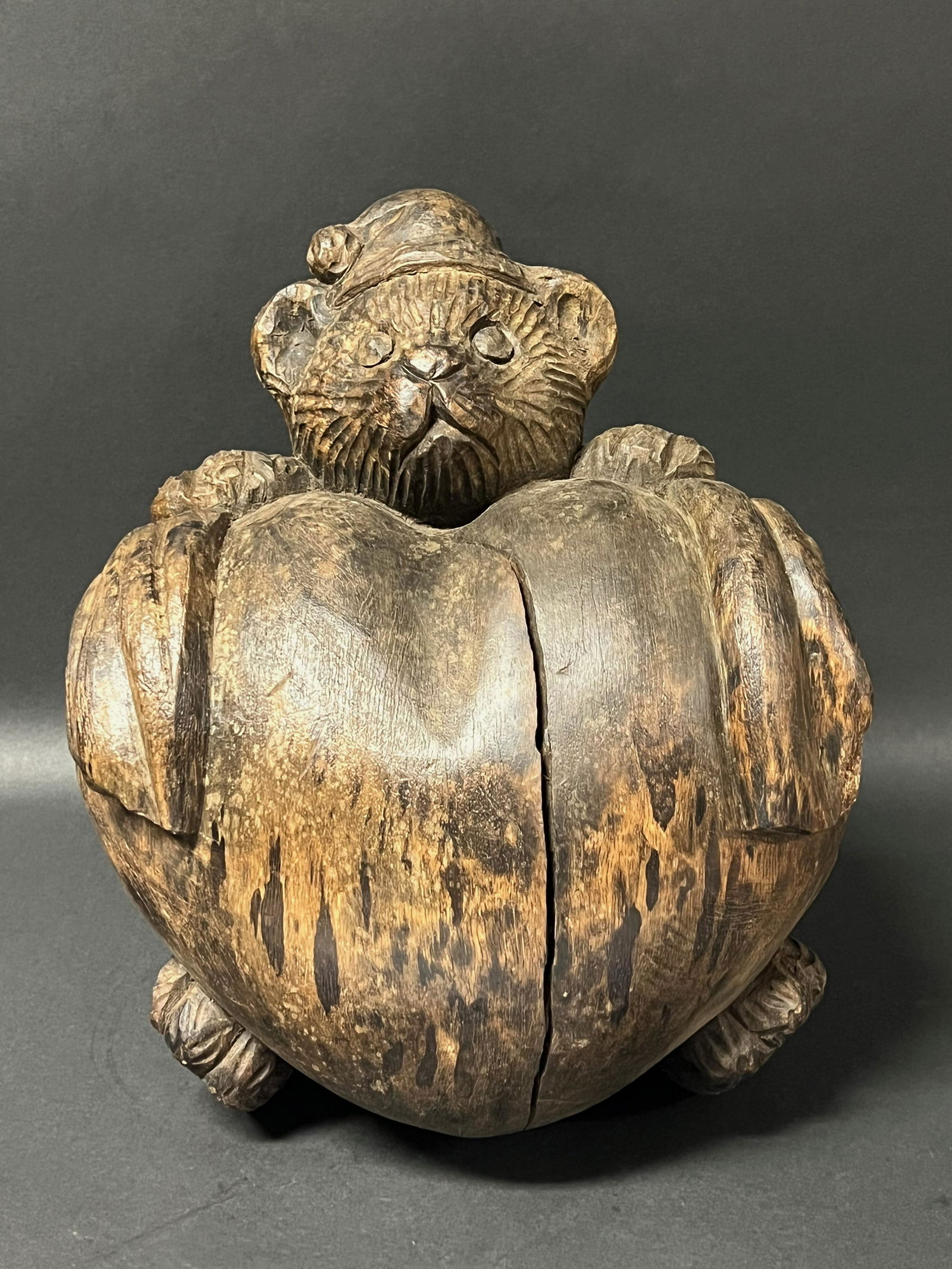 Teddy Bear Hugging a Heart Sculpture: Title: Teddy Bear Hugging a Heart Sculpture Date/Period: Late 20th Century Dimension: 13" h x 6.5" w Materials: Wood Additional Information: Carved Wooden Folk Art Teddy Bear hugging a Heart Sculpture