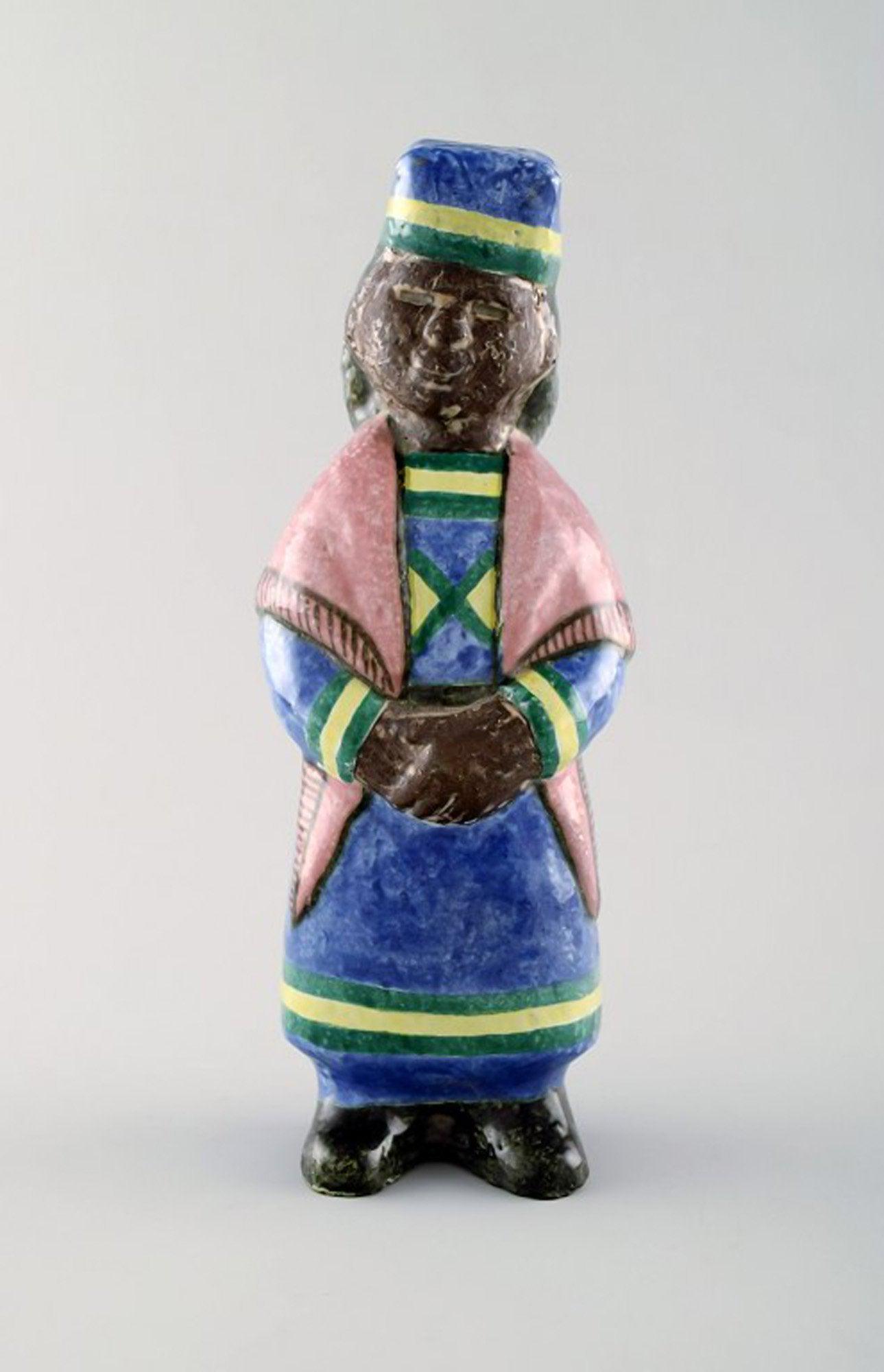 Rare MARI SIMMULSON figure of woman, ceramics, Upsala-Ekeby.: Rare MARI SIMMULSON figure of woman, ceramics, Upsala-Ekeby. Height 21.5 cm. Width 7.5 cm. In perfect condition. Stamped. Reserve: $413.00 Shipping: Domestic: Shipping rates are determined by destinat