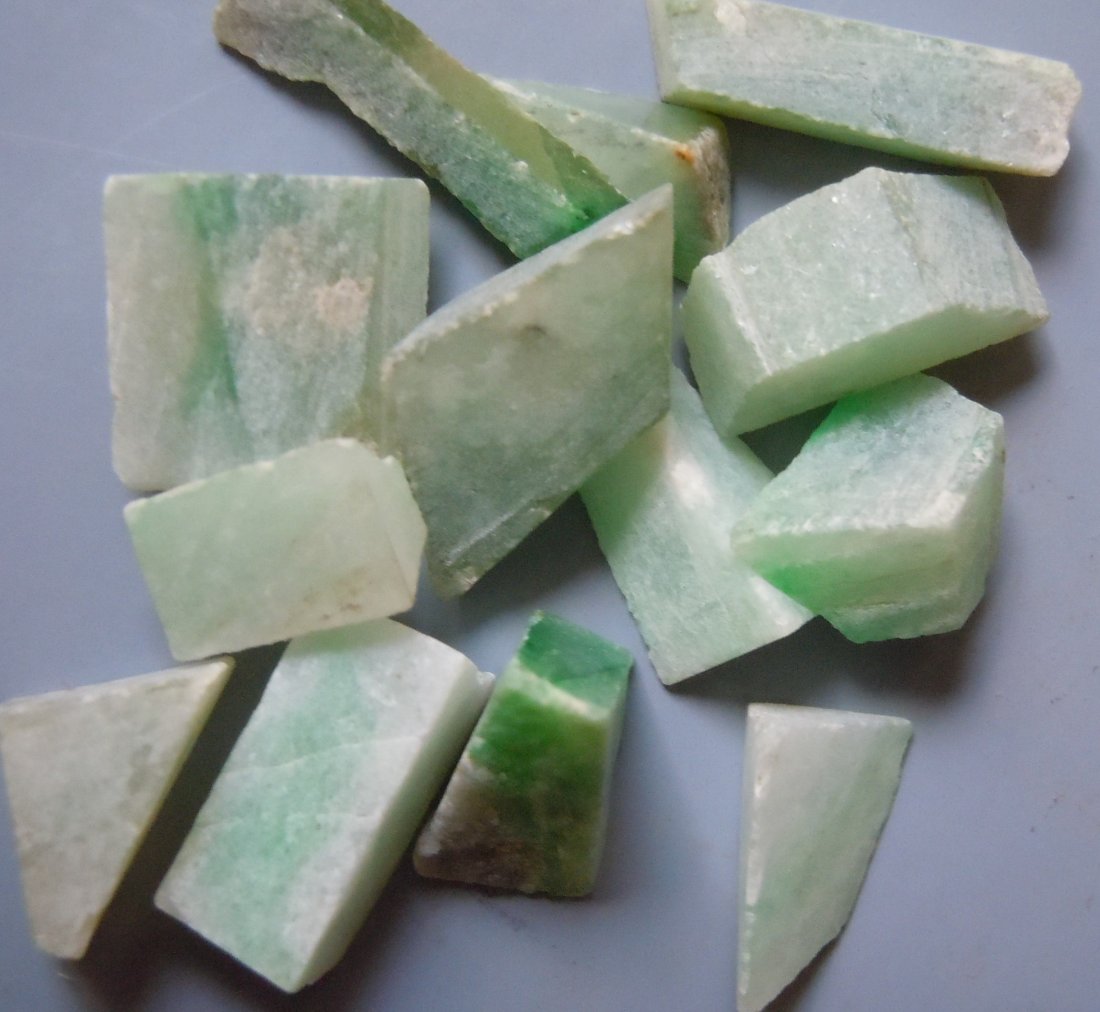 5.52 GRAM SET OF 13 JADEITE JADE: Title: 5.52 GRAM SET OF 13 JADEITE JADE Origin: Hpakant, Kachin State, Myanmar Size: 0.6-1.5 cm / 5.52 gram set of 13 jadeite jade cut pieces Reserve: $3.00 Shipping: Domestic: Flat-rate of $6.00 to a