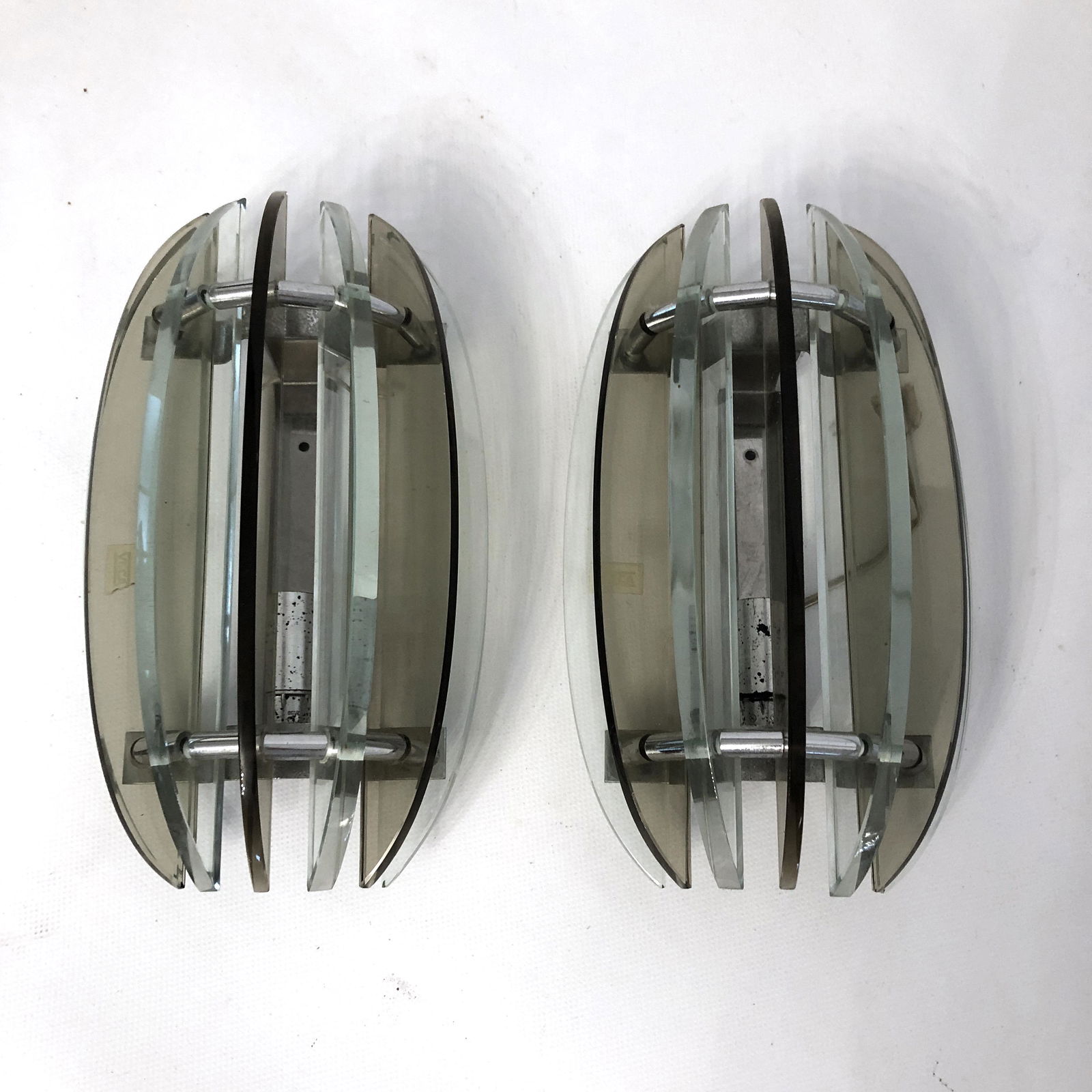 Veca, pair of Italian signed glass sconces from 60s: This pair of glass and chrome sconces have been produced from the Italian Veca during the 60s. Very good vintage condition with trace of age and use. No chips or cracks. Material: glass, chrome Dimens