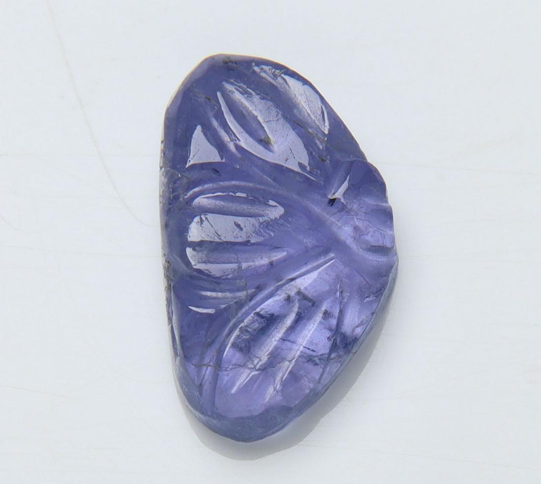 3.90 Cts Natural Tanzanite Carving: No Reserve! Title: 3.90 Cts Natural Tanzanite Carving Additional Information: Gemstone : Natural Tanzanite Carving Origin: Tanzania Weight : 3.90 carats Dimensions : 13x8 mm Shape/Cut: Fancy Carving C