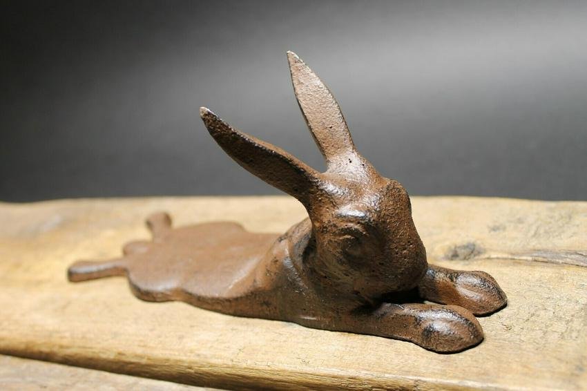 Cast Iron Door Stop Rabbit Hare Wedge Rust/Black: 8" Long x 2 3/8" WideNice Reproduction antique solid cast iron rust/black rabbit door wedge. This rabbit is much thicker, and heavier then other similar ones we have seen. Please see the images, this