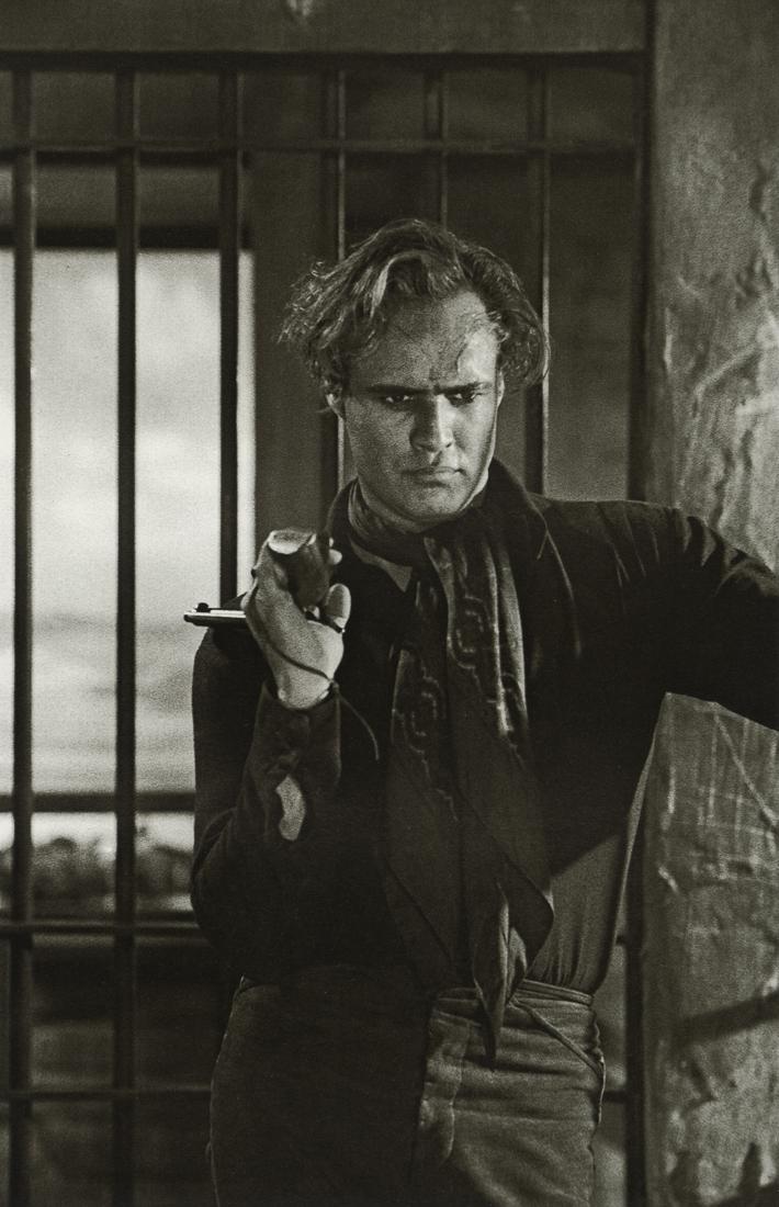 SAM SHAW - Marlon Brando, "One Eyed Jacks", 1958: Artist: Sam Shaw Title: Marlon Brando, "One Eyed Jacks", Monterey, California, 1958 Medium: Photo Litho, 2004, Italy Dimensions: 5.35x8.25" Description: Heat Wax Mounted on 8.5x11" Conservation Board