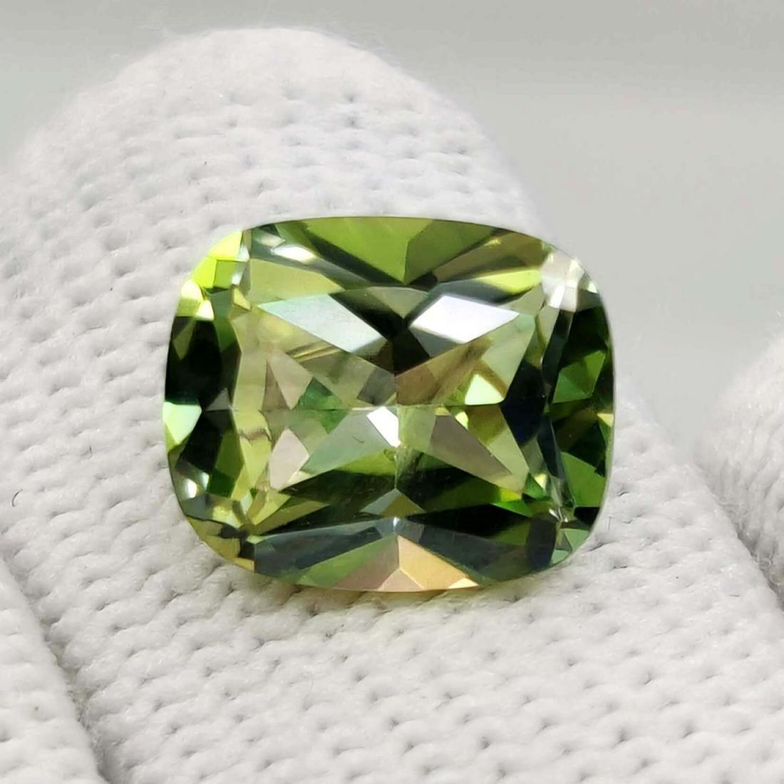 6.51 ct Rare Natural Kiwi Mystic Topaz: Title: 6.51 ct Rare Natural Kiwi Mystic Topaz Additional Information: Gemstones: Mystic Topaz Carat Weights: 6.51 ct Size/Dimensions: 12 X 10 mm Treatment: Coated Materials & Techniques: Topaz,Stone R