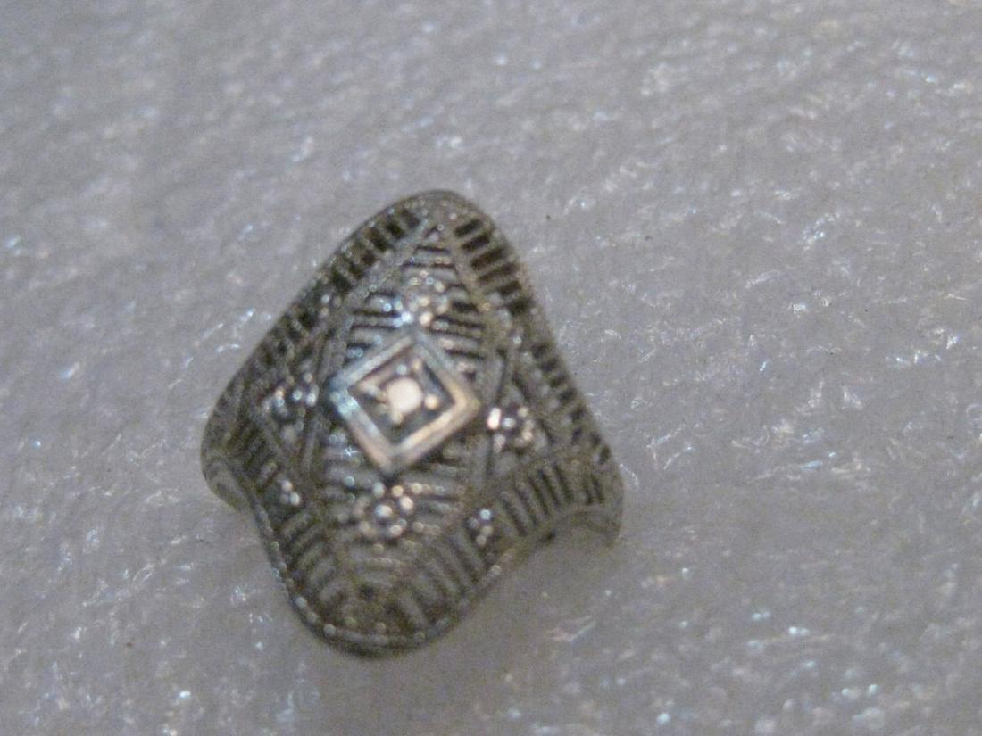 Vintage Art Deco 14kt Filigree Diamond Ring, Size 5, 1.91 grams. 3/4" long, Single 1.5mm Diamond: Vintage from the 1910s Size: 5 US Materials: gold, diamonds Description Vintage 14kt White Gold Art Deco Engagement Ring, Filigree, size 5, 1.91 grams. This is 3/4" long and about the a me wide as it