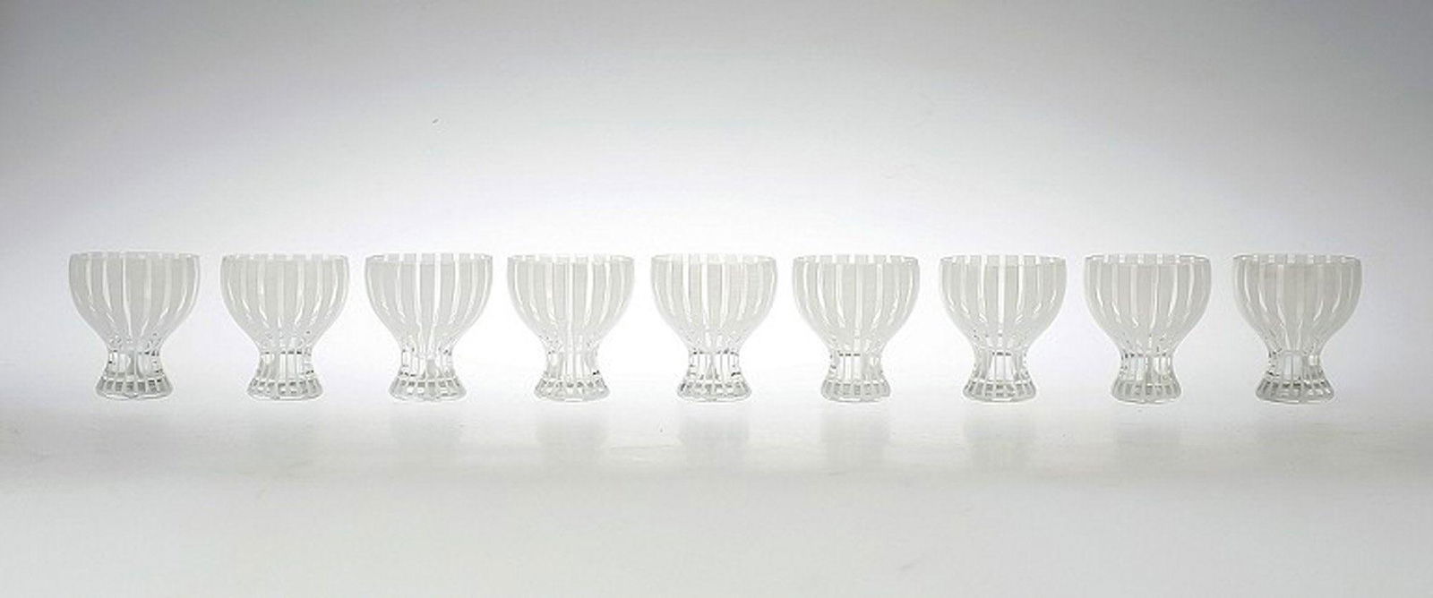 9 Cocktail Glass "Strict", Bengt Orup, Johansfors.: 9 Cocktail Glass "Strict", Bengt Orup, Johansfors. 1950s. White. Height 8 cm. In good condition, 2 glass with a crack. Reserve: $525.00 Shipping: Domestic: Shipping rates are determined by destination