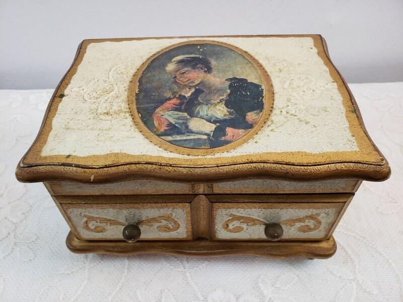 Vintage Florentine Box Wooden Jewelry Box Music Box Wind up Gold Gilt: Vintage from the 1950s Materials: wood, metal Description Vintage Gold Florentine Wooden Jewelry and Music Box Combo Overall in good condition with scratches, stains and wear Measures 8.5"W x 5"H x 6"