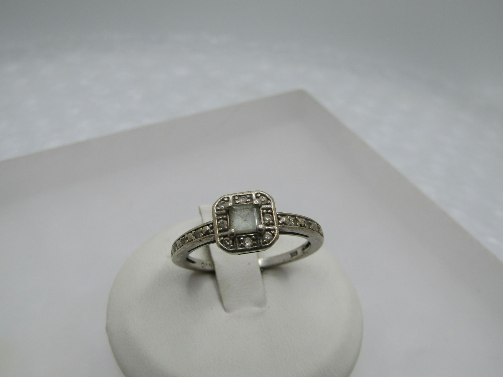 Vintage Sterling CZ Halo Ring, Signed Nataliya Collister, Sz. 8: Vintage Sterling CZ Halo Ring, Signed Nataliya Collister, Sz. 8 this has a square clear cz on top with a halo around it with small czs. The top of the ring is appx. 8mm square with cut corners. the ba