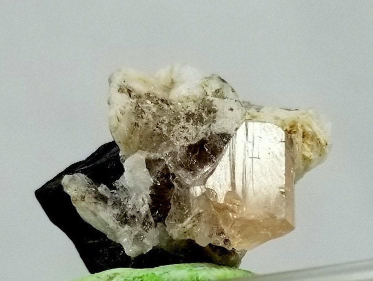 12 Gram Beautiful Natural Topaz Crystal With Black Tourmaline Crystal Specimen From Skardu pakistan: Materials: Topaz, Black Tourmaline ITEMS.....Topaz Crystal With Black Tourmaline weight 12 Gram size... 19mm 16mm 26mm COLOR.... SHERRY TOPAZ AND BLACK TOURMALINE LOCALITY.....SKARDU PAKISTAN TREATMEN