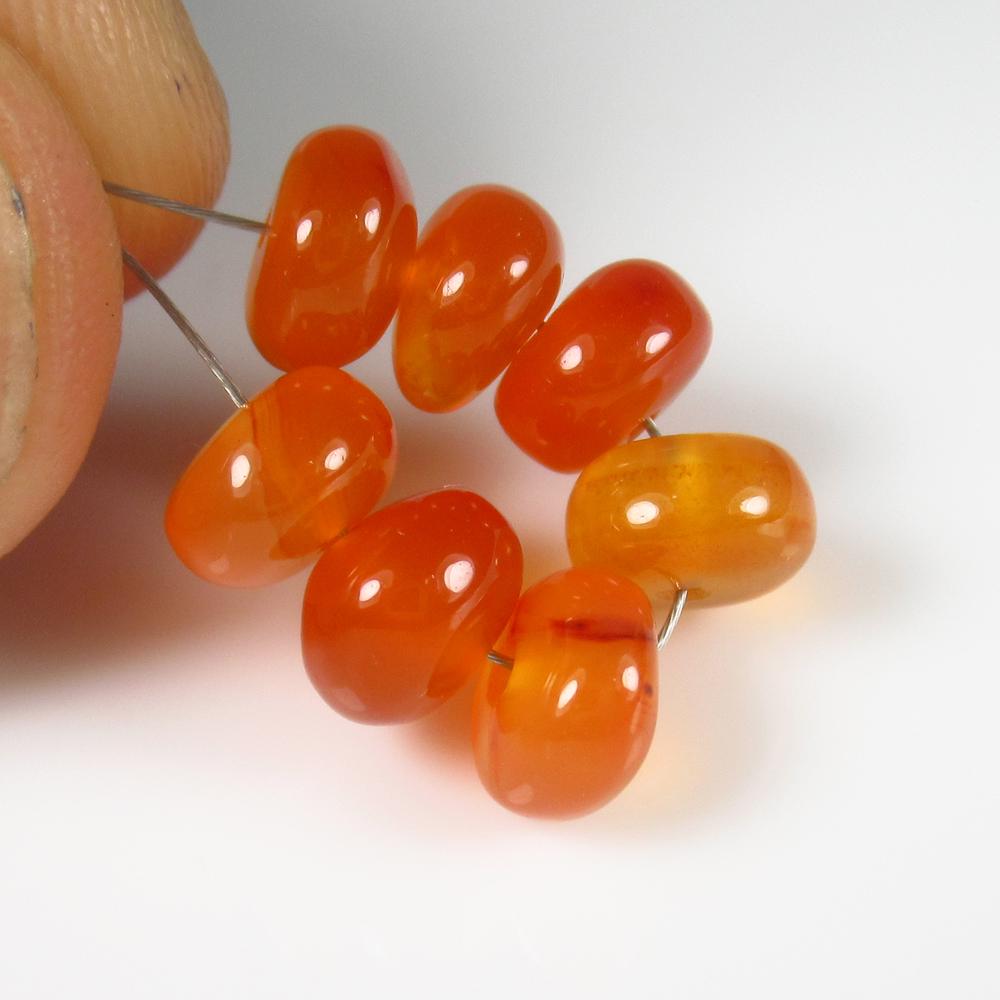 Natural Carnelian Beads - 10.78 Ct: No Reserve! Title: Natural Carnelian Beads - 10.78 Ct Origin: Brazil Weight: 10.78 Size/Dimensions: 6.8 - 7.3 mm Additional Information: Pieces : 7 No's / Shape : Drilled Round Beads / Color : Orange 