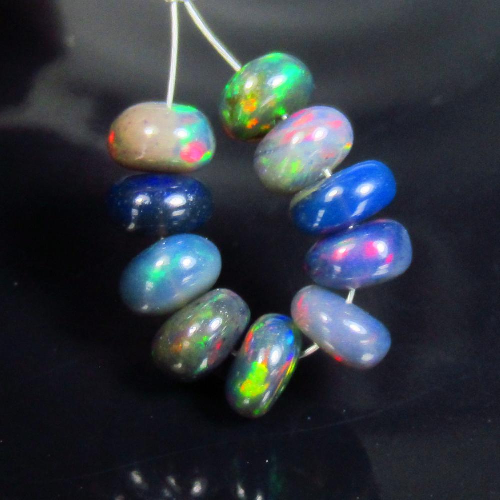 4.40 Ctw Natural 10 Drilled Black Fire Opal Beads: No Reserve! Title: 4.40 Ctw Natural 10 Drilled Black Fire Opal Beads Stone Clarity: Transparent Gemstones: Natural Black Opal Beads Carat Weights: 4.4 Size/Dimensions: 5.20 - 5.70 mm / 10 Pc's Additio