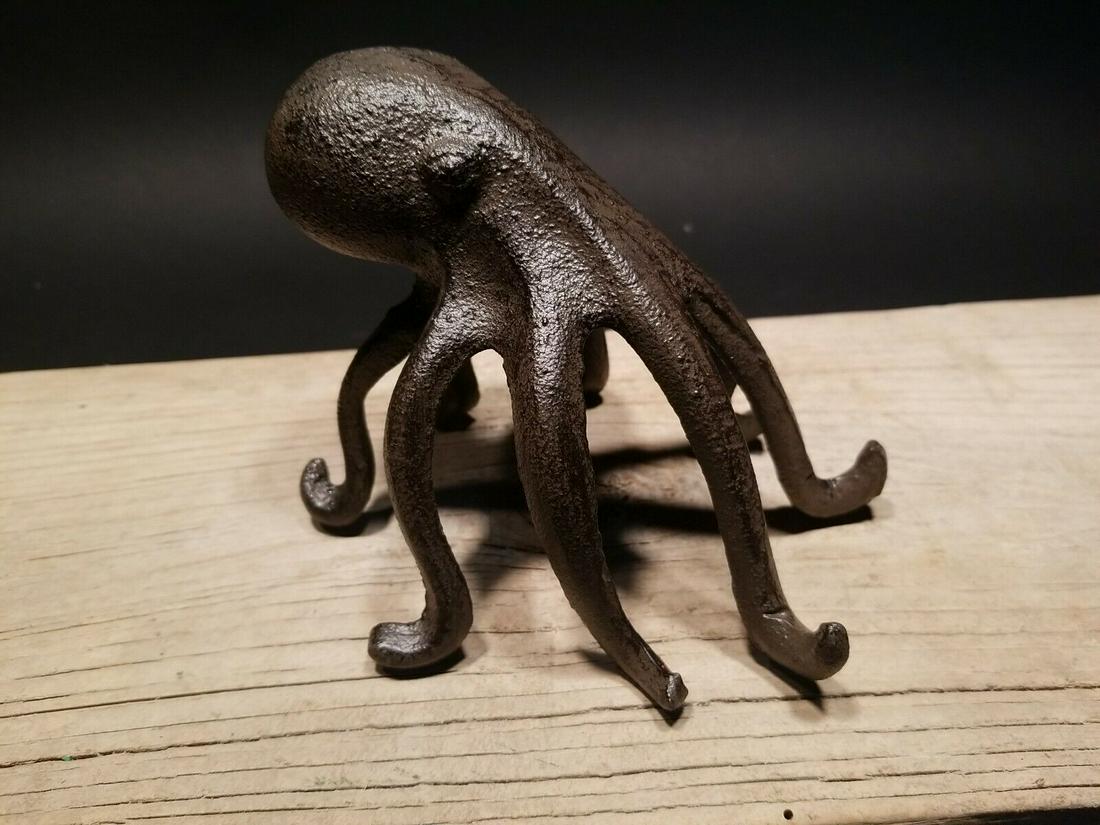 Cast Iron Octopus Phone Stand Paperweight: 4 1/2" Tall x 6" wide Introducing our charming Cast Iron Octopus Phone Holder Stand! ���� This sturdy and eye-catching piece serves as both a functional phone holder and a 