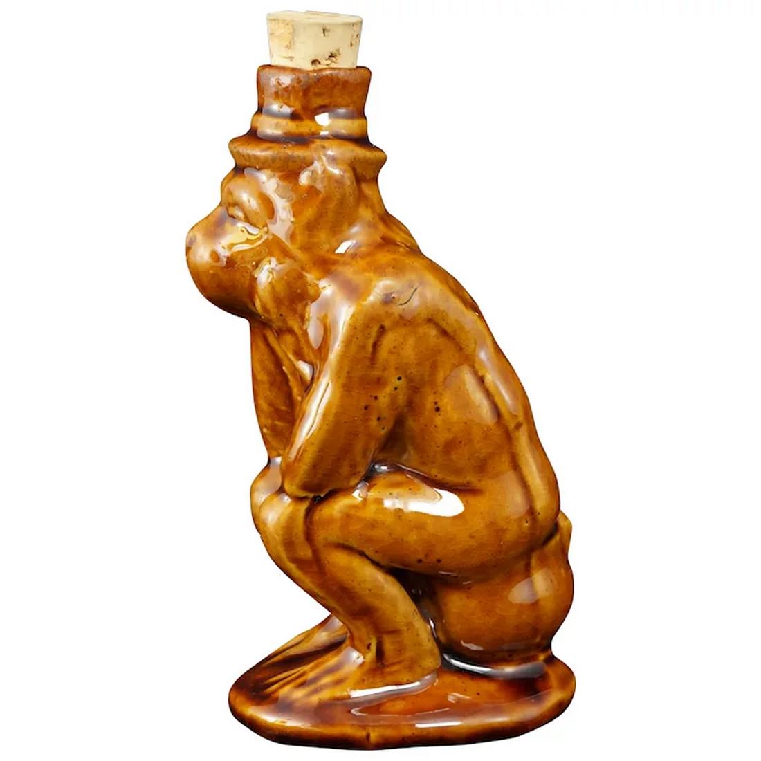 Roseville Flask Monkey Sitting On A Chamber Pot: Title: Roseville Flask Monkey Sitting On A Chamber Pot Size: 5 7/8” (14.9 cm) tall x 3” (7.6 cm) deep x 2 ¾” (7.0 cm) wide. Description:A fun bottle made by Roseville in the sha