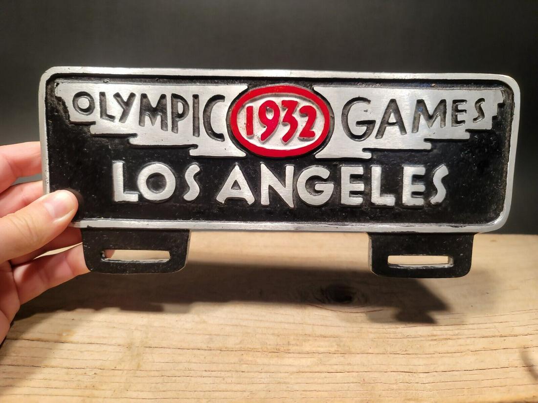 Aluminum Olympic Games 1932 License Plate Fob Topper: 4 3/4" tall x 10 7/8" wide Wonderful reproduction license plate topper. Good detail aluminum, slightly aged to look like an antique. Certainly hard to tell its age. Reserve: $25.00 Shipping: Domestic: