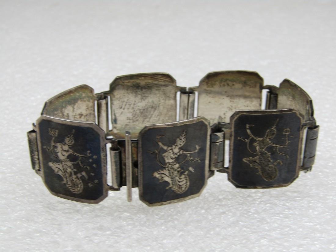 Vintage Sterling Enameled Siam Niello Goddess Bracelet, 6.5": Vintage Sterling Enameled Siam Goddess Bracelet, 6.5" and appx. 21mm wide with seven tiles that are rectangular and cut on the corners with a sterling frame and goddess and black enameling. Age is app