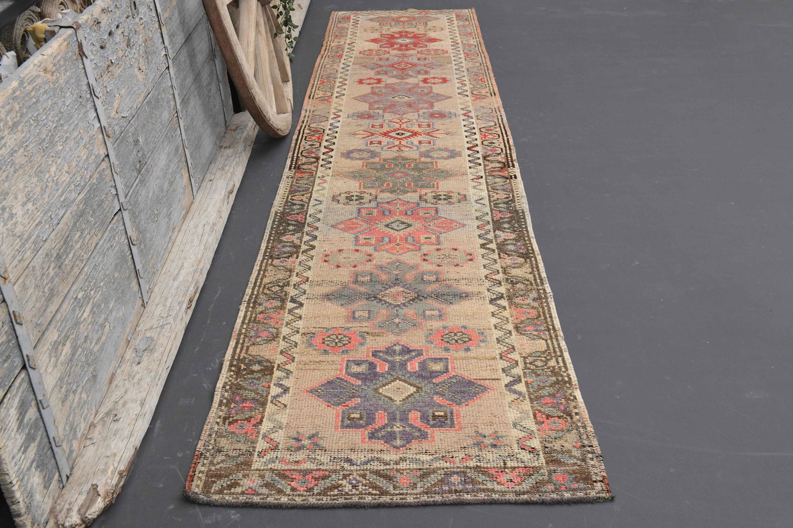 3x12 Beige Purple Pink Turkish Rug: Title: 3x12 Beige Purple Pink Turkish Rug Origin: Turkey Date/Period: 1960 - 1970 Dimension: Width: 2.8 feet Length: 12.6 feet Materials: Wool And Cotton Description: This Turkish Rug one-of-a-kind Vi