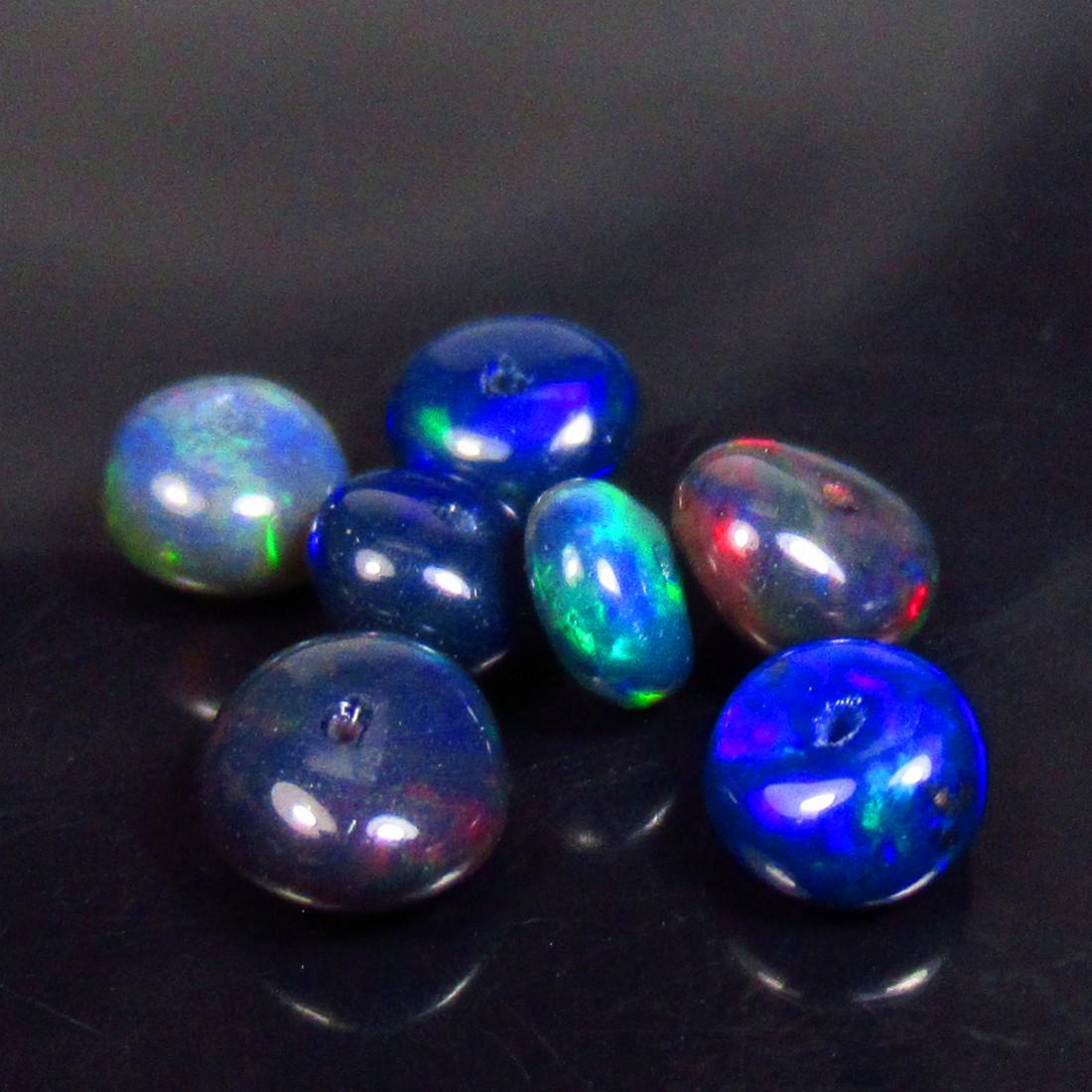 3.88 Ctw Natural 7 Drilled Black Fire Opal Beads: No Reserve! Title: 3.88 Ctw Natural 7 Drilled Black Fire Opal Beads Stone Clarity: Transparent Gemstones: Natural Black Opal Beads Carat Weights: 3.88 Size/Dimensions: 5.10 to 6.10 mm / 7 PC's Additio