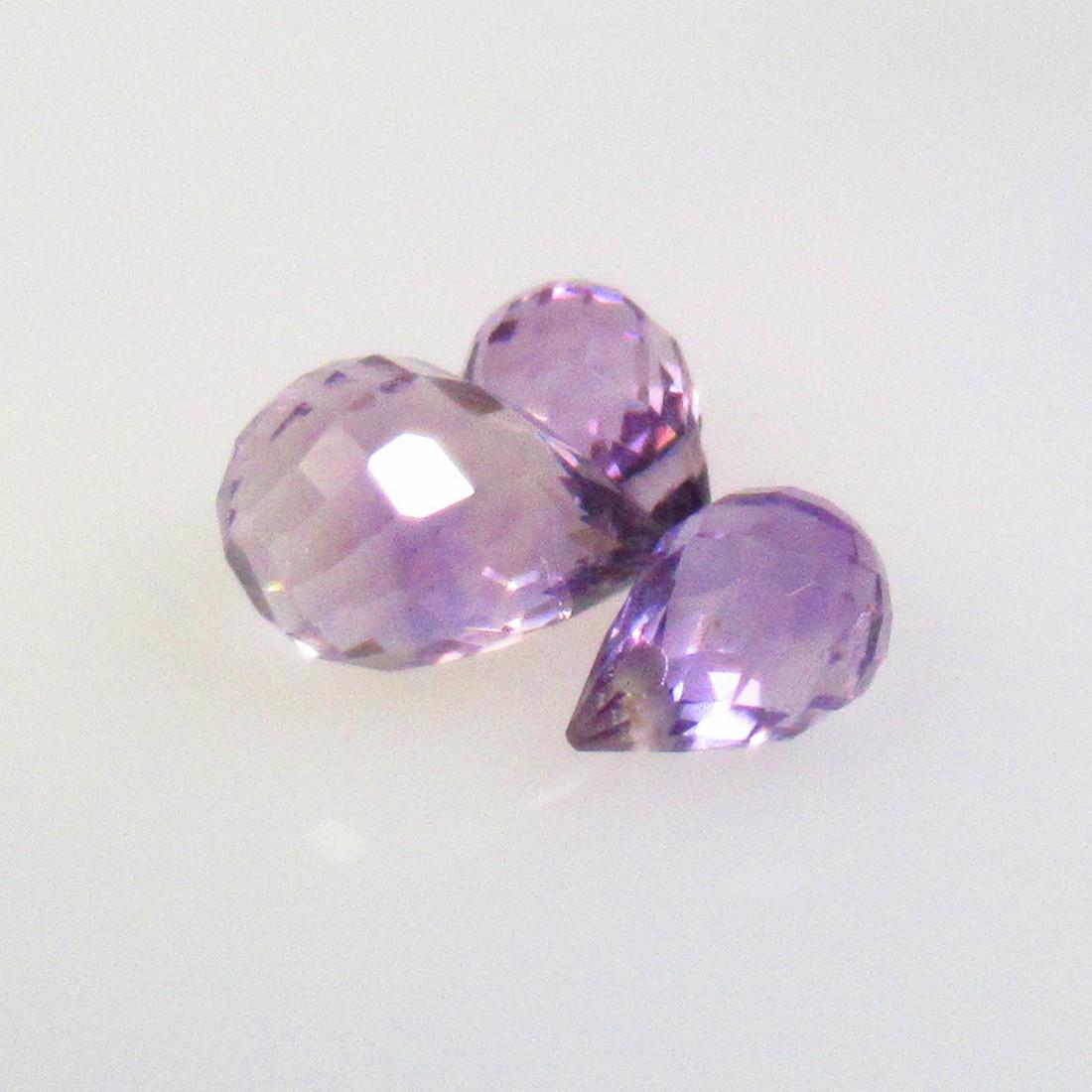 3.10 Ctw Natural 3 Drilled Purple Amethyst Pear Drop Beads: No Reserve! Title: 3.10 Ctw Natural 3 Drilled Purple Amethyst Pear Drop Beads Stone Clarity: Transparent Gemstones: Natural Amethyst Beads Carat Weights: 3.1 Size/Dimensions: 6.5x4.5 - 8.5x5.9 mm / 3 