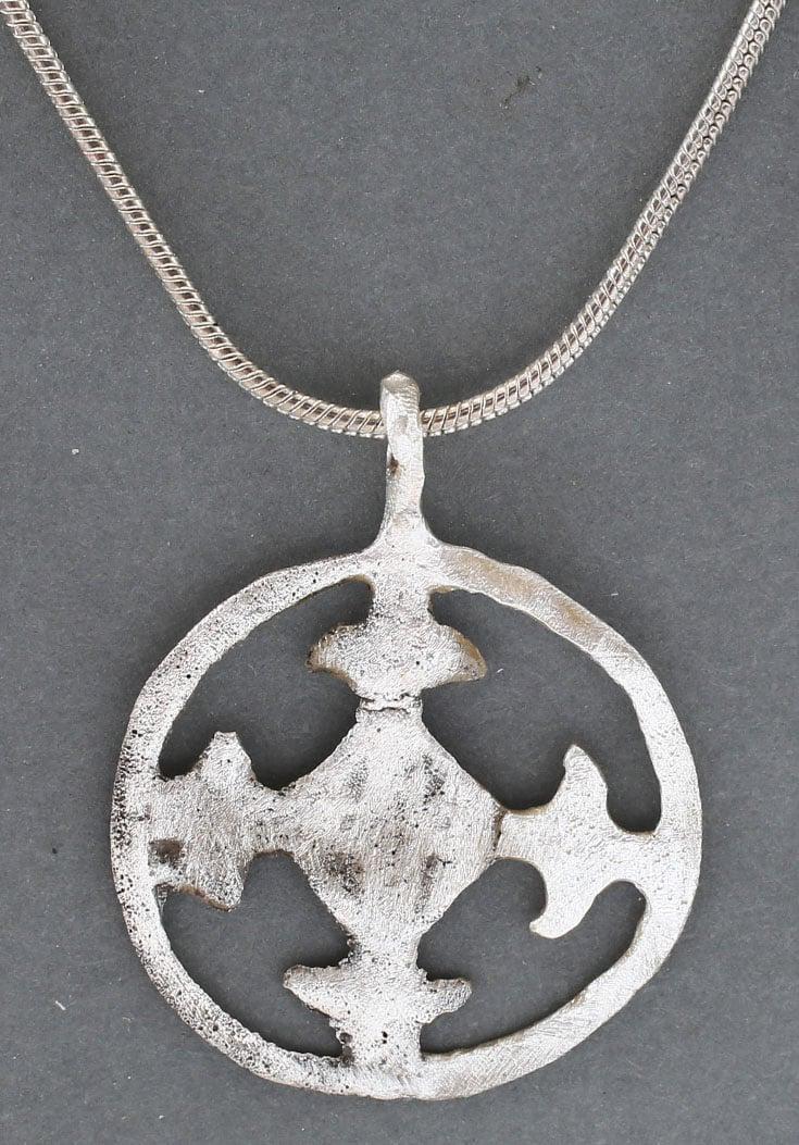 FINE EUROPEAN CRUSADER’S CROSS 1096-1291 AD: 1096-1291. Circular, pierced with a cross potent, i.e. with "crutches" at the beam ends. That form is also known as the Crusader's cross, having been an element in the arms of Godfrey Bouillon which h