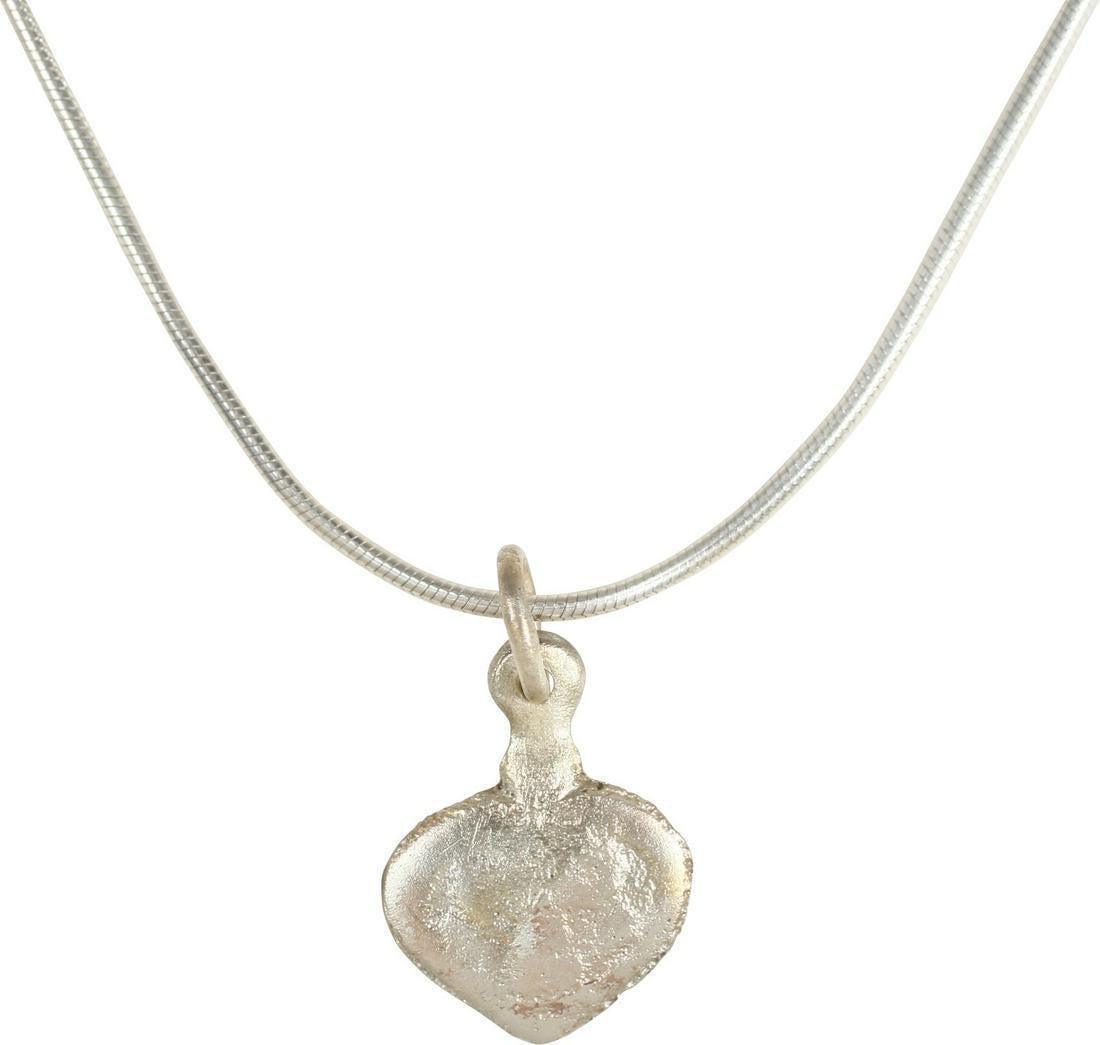 VIKING HEART PENDANT NECKLACE C.950-1050 AD: Charm size, ½” width. The Viking heart in its fully developed form with full cusp top formed by the foliate ends of the broadly curved edges. Relatively flat section, produced by the open f