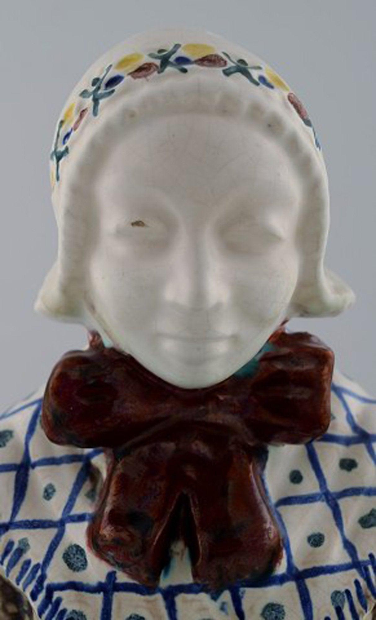 Michael Andersen Ceramics from Bornholm. Large figure of woman with Songbook in national dress. No.: Michael Andersen Ceramics from Bornholm. Large figure of woman with Songbook in national dress. No. 4418-3. Measures: 32 x 10 cm. Perfect condition. Stamped. Reserve: $119.00 Shipping: Domestic: Shipp