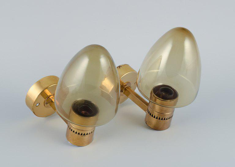 Hans Agne Jakobsson, Sweden, a pair of wall sconces in brass and smoked glass. (1 of 4)