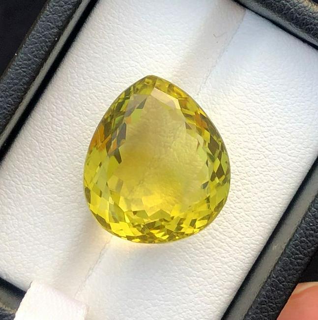 20.5 Carats Natural Lemon Quartz: Title: 20.5 Carats Natural Lemon Quartz Gemstones: Lemon Quartz Carat Weights: 20.5 Carats Size/Dimensions: 18.5x16x10 MM Additional Information: Natural Reserve: $99.00 Shipping: Domestic: Flat-rate