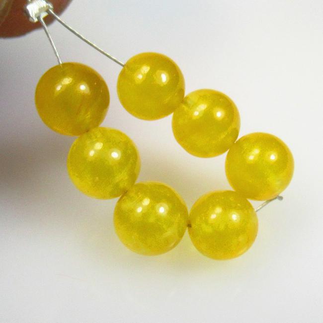 11.70 Ctw Natural 7 Drilled Yellow Onyx Round Beads: No Reserve! Title: 11.70 Ctw Natural 7 Drilled Yellow Onyx Round Beads Stone Clarity: Semi-Transparent Gemstones: Natural Onyx Beads Carat Weights: 11.70 Size/Dimensions: 6.10 - 6.70 mm / 7 P'cs Addit