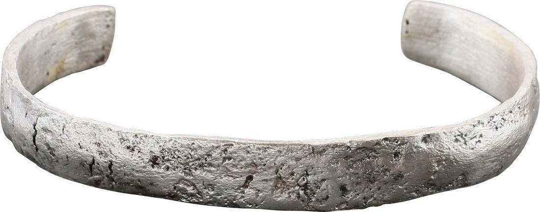 ANCIENT VIKING WOMAN'S BRACELET C.900-1050 AD: 2 5/8" inside dimension which easily fits an average woman. C form, tapered from its center to the slightly swelled ends. Silvered bronze, broad section with slightly rounded face. Surface textured fr