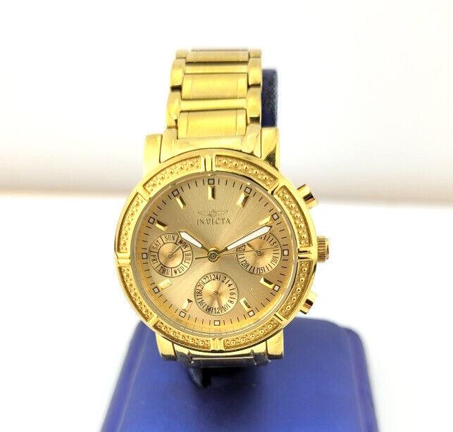 Designer $399 Ladies Invicta Tritnite Golden Tone Stainless Steel Watch: Designer Ladies Invicta Tritnite Golden Tone Stainless Steel Watch Golden tone stainless steel watch Watch measures 6.5" long Bracelet measures 5/8" wide Case measures 39.14 x 35.40mm including lugs C