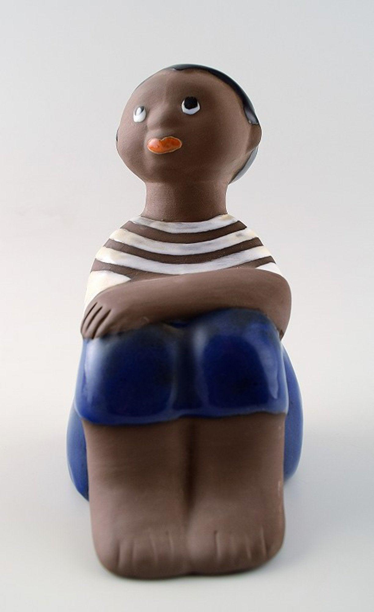 Mari Simulson, Upsala-Ekeby. Signed. Figure of boy.: Mari Simulson, Upsala-Ekeby. Signed. Figure of boy, number 7035M. In perfect condition. Measures 17 cm. Reserve: $140.00 Shipping: Domestic: Shipping rates are determined by destination International: