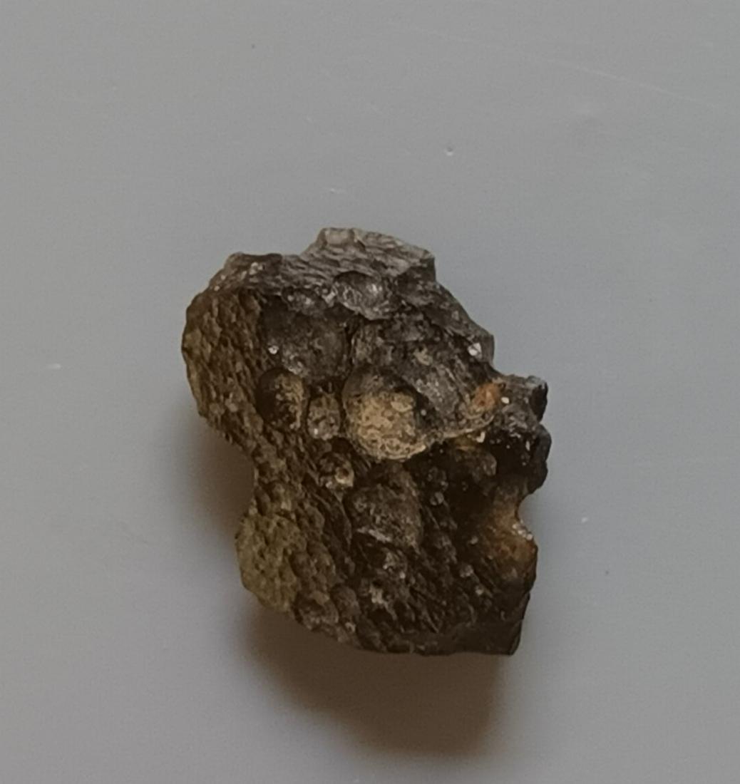 PHILIPPINITE TEKTITE - FROM METEORITE IMPACT: Title: PHILIPPINITE TEKTITE - FROM METEORITE IMPACT Origin: Anda, Cabarruyan Isl. Pangasinan, Luzon, Philippinines Size: 1.5x1.1x0.8 cm / 1.11 gram Description: irregular flattened & structured philip