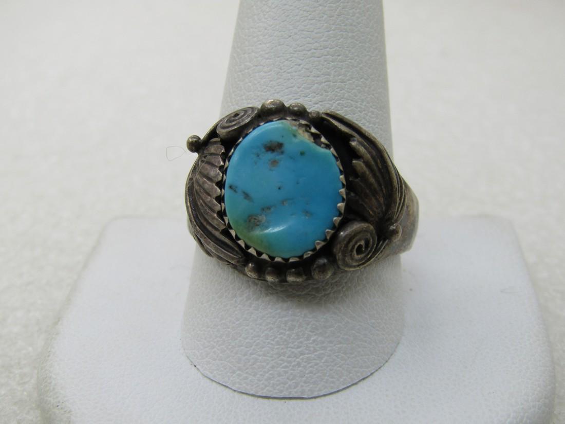 Vintage Southwestern Turquoise Ring, Sz. 12, Feather & Scrolled Designs: Vintage Southwestern Turquoise Ring, Sz. 12, Feather & Scrolled Designs. Age is appx. 1960's-1970's. It has a 12.5mm by 10.5mm oval turquoise stone which is sawtooth bezel-set. It is decorated with fe