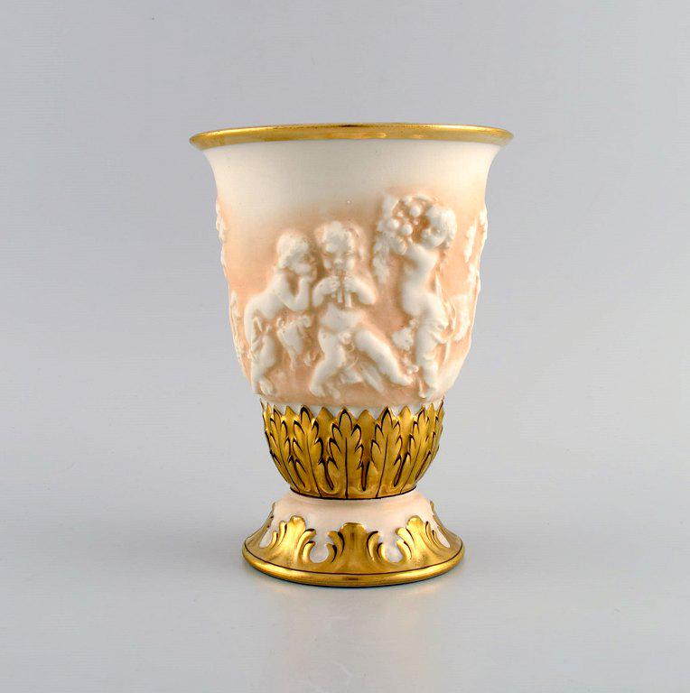 Capodimonte, Italy. Antique porcelain vase with putti in relief and hand-painted gold decoration.: Capodimonte, Italy. Antique porcelain vase with putti in relief and hand-painted gold decoration. Early 20th century. Measures: 18 x 13.5 cm. In excellent condition. Signed. Reserve: $280.00 Shipping: