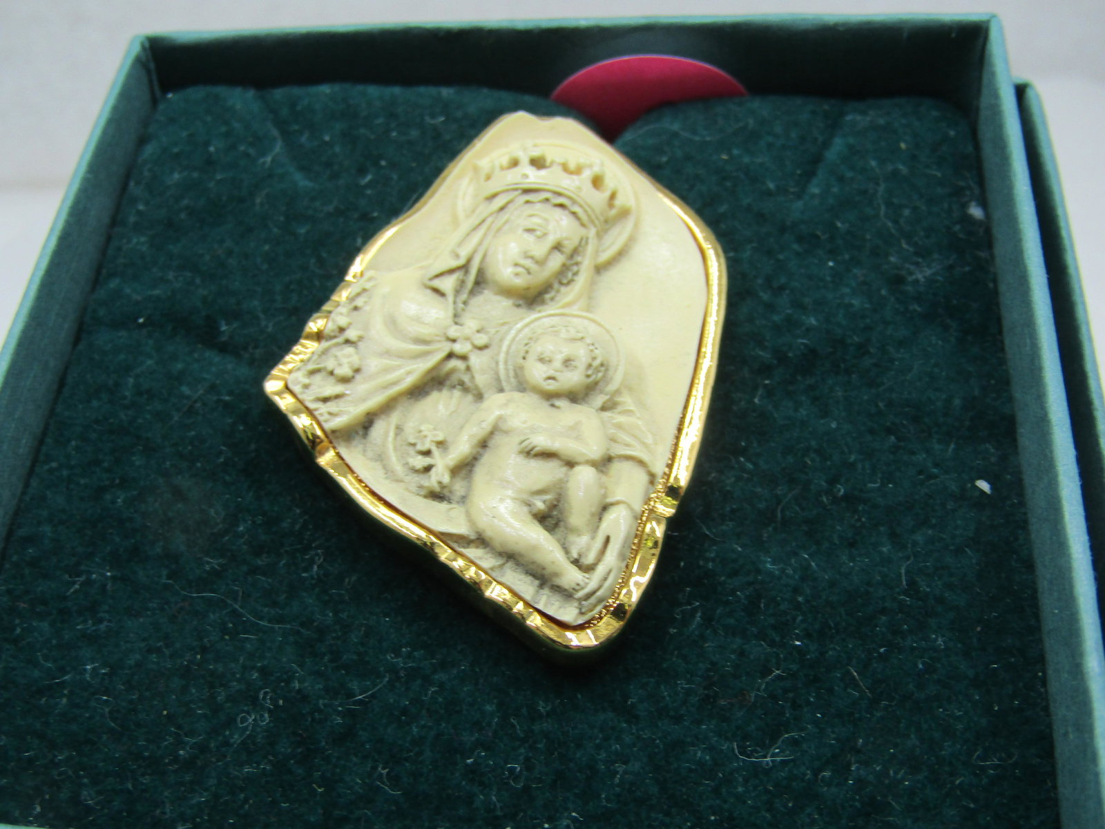 Vintage Mother & Child Brooch Vatican Library Collection in Box: Vintage Mother & Child Brooch Vatican Library Collection in Box with insert and original tag. It is a raised image of mother and child in an irregular shape with gold tone bezel and undercarriage with