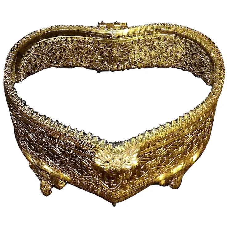 Vintage Beveled Glass Gold Tone Filigree Heart-shaped Jewelry Casket: This vintage beveled glass gold tone filigree heart-shaped jewelry trinket box with hinged lid, floral lip, and black velvet interior is in excellent condition. The stunning filigree design surrounds 