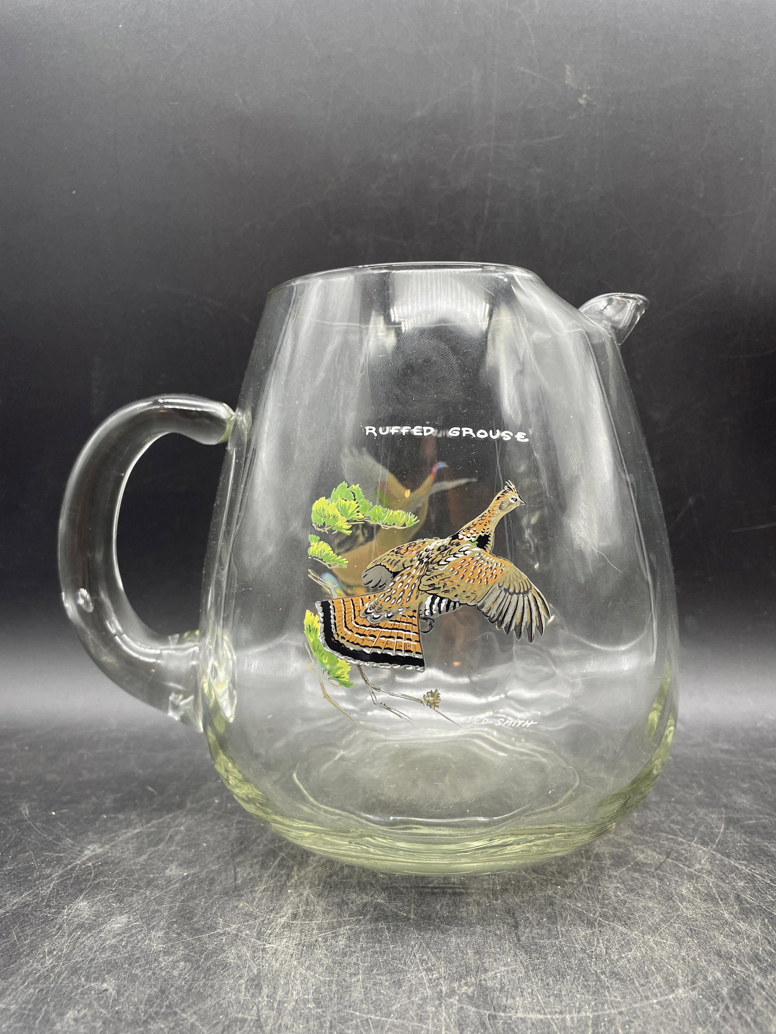 Vintage NED SMITH ORVIS OPTIC LOOP PITCHER RUFFEDGROUSE/WILD TURKEY MCM BARWARE: Title: Vintage NED SMITH ORVIS OPTIC LOOP PITCHER RUFFEDGROUSE/WILD TURKEY MCM BARWARE Date/Period: approx 1950-60's Dimension: approx 7" x 6.5" Material: glass Additional Information: Vintage NED SMI