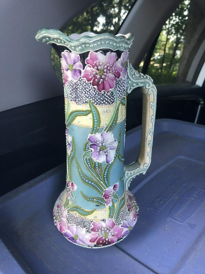 Nippon Moriage Pitcher: It is 10 1/4” high and dates around 1900. It has a 1 1/4” craze line on the top rim that doesn’t go through and is missing 10 tiny dots.otherwise it has no other issues.it has excell
