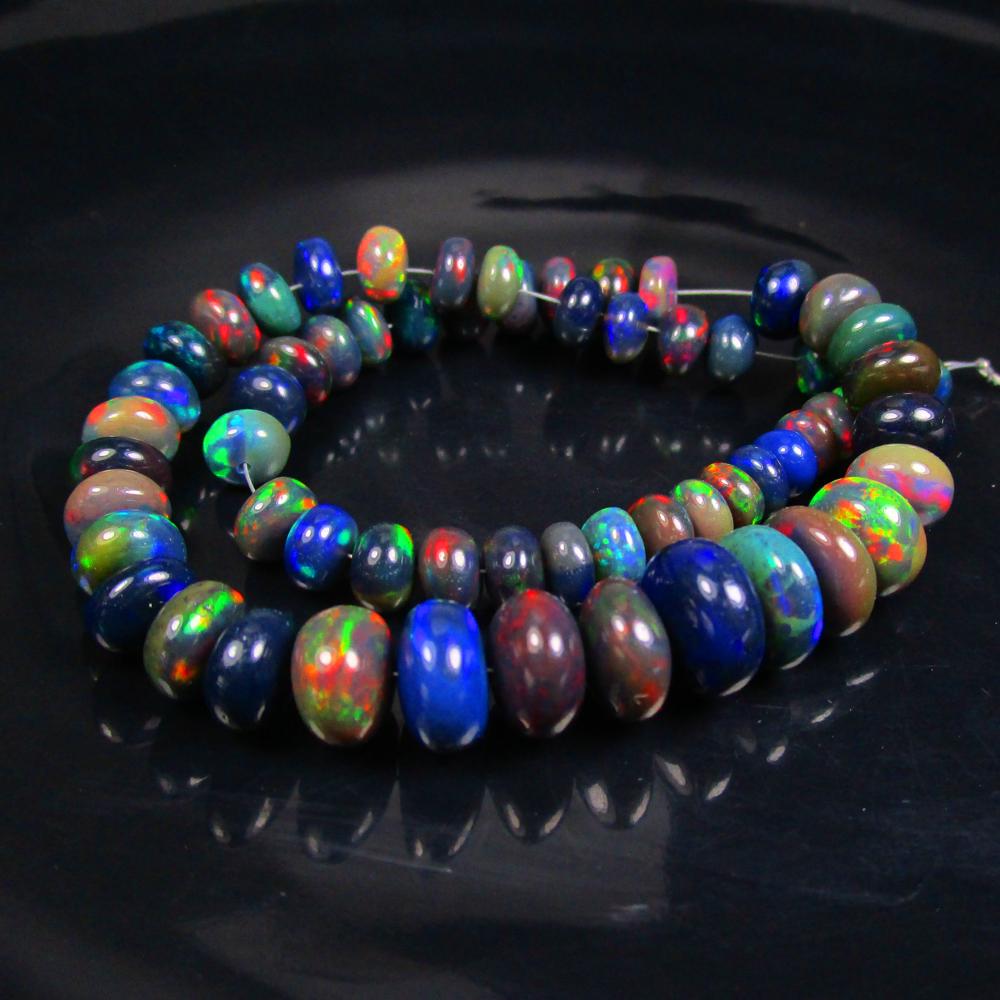 62.91 Ctw Natural 63 Drilled Black Fire Opal Round Beads: Title: 62.91 Ctw Natural 63 Drilled Black Fire Opal Round Beads Stone Clarity: Transparent Gemstones: Natural Black Opal Beads Carat Weights: 62.91 Size/Dimensions: 5.70 - 10.00 mm / 63 P'cs Additiona
