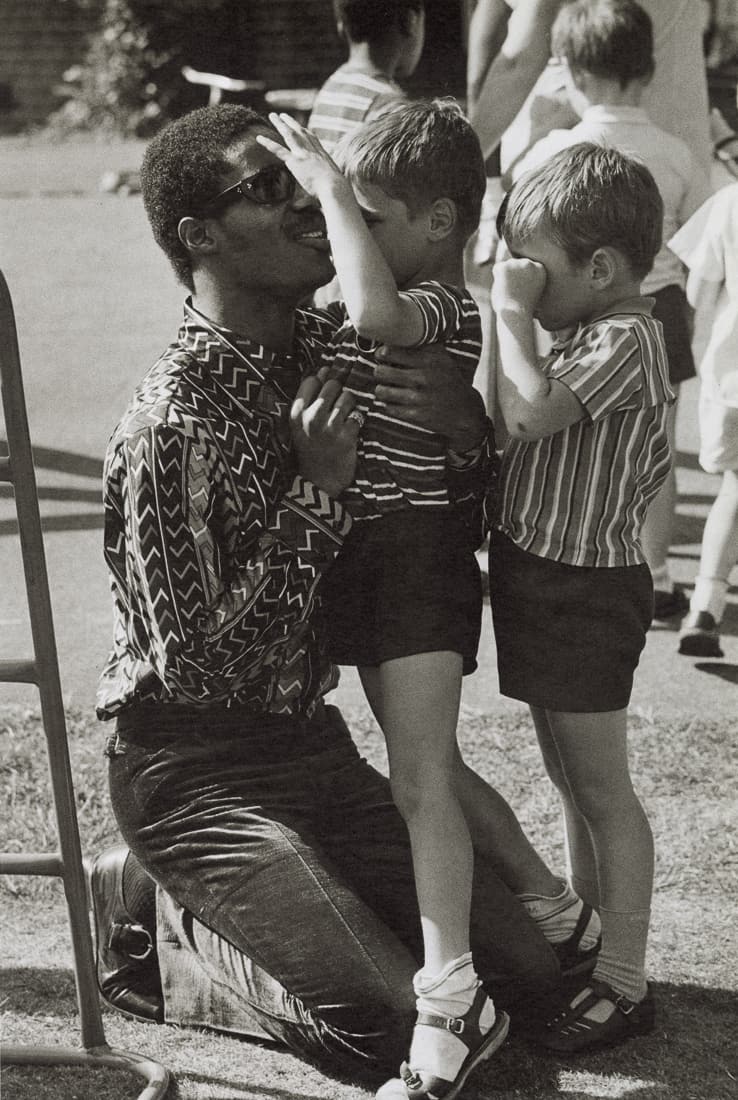 TERRY O'NEILL - Stevie Wonder at a Home for the Blind: Artist: Terry O'Neill Title: Stevie Wonder at a Children's Home for the Blind, London, 1970 Medium: Photo Litho, 1985, Italy Dimensions: 6.4x9.5" Description: Heat Wax Mounted on 11x14" Conservation b
