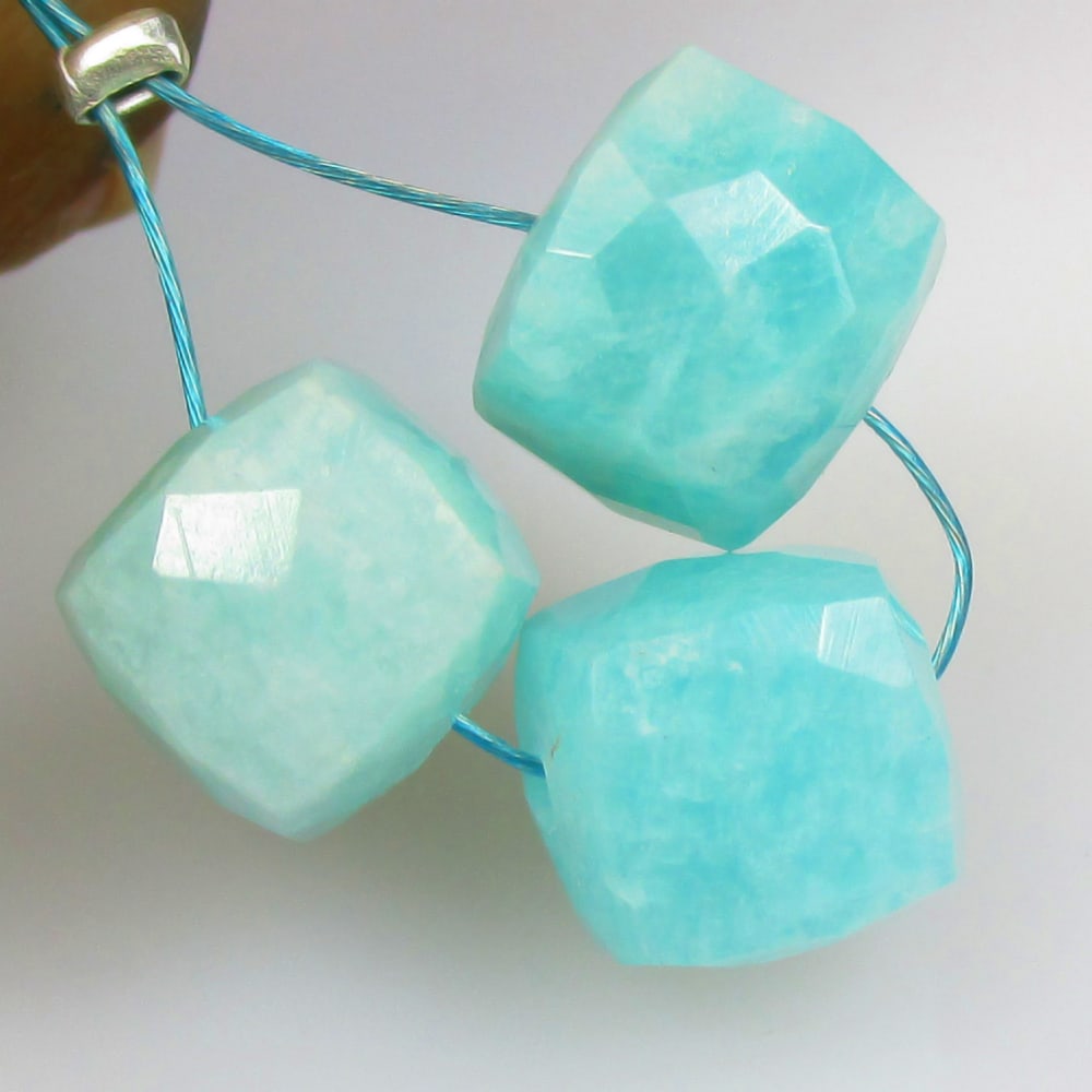 10.68 Ctw Natural 3 Drilled Amazonite Square Beads: No Reserve! Title: 10.68 Ctw Natural 3 Drilled Amazonite Square Beads Stone Clarity: Opaque Gemstones: Natural Amazonite Beads Carat Weights: 10.68 Size/Dimensions: 7.7x7.7 - 8.0x8.0 mm / 3 Pc's Addit